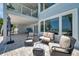 Inviting outdoor patio area with plush seating, water view and shade, perfect for relaxing and enjoying the waterfront at 7115 Bay St, St Pete Beach, FL 33706