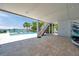 Covered patio with seating area, pool access and waterfront views at 7115 Bay St, St Pete Beach, FL 33706