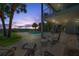 Inviting outdoor patio with comfortable seating, a swimming pool, and stunning waterfront views at 7115 Bay St, St Pete Beach, FL 33706