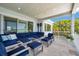 Covered patio features comfortable lounge seating and beautiful views, creating an ideal outdoor living space at 7115 Bay St, St Pete Beach, FL 33706