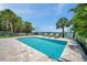 Beautiful pool surrounded by lush tropical landscaping and lounge chairs overlooking the canal at 7115 Bay St, St Pete Beach, FL 33706