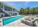 Beautiful backyard with a sparkling pool and lounge chairs for relaxation at 7115 Bay St, St Pete Beach, FL 33706