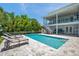 Inviting pool area featuring comfortable lounge chairs and lush landscaping at 7115 Bay St, St Pete Beach, FL 33706
