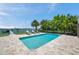 Lush backyard featuring a refreshing pool and beautiful waterfront views at 7115 Bay St, St Pete Beach, FL 33706