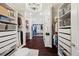 Spacious walk-in closet with wood floors, custom shelving, and a chandelier at 7115 Bay St, St Pete Beach, FL 33706