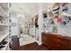 Custom walk-in closet featuring dark wood floors, a chandelier, and a decorative hat wall at 7115 Bay St, St Pete Beach, FL 33706
