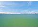 Expansive waterfront view with calm turquoise water under a sunny blue sky, showcasing the serene coastal environment at 7115 Bay St, St Pete Beach, FL 33706