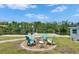 Backyard fire pit area with seating and waterway views, ideal for relaxation at 825 Seabreeze Dr, Ruskin, FL 33570
