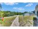 Landscaped backyard featuring a charming fire pit and dock, ideal for outdoor enjoyment at 825 Seabreeze Dr, Ruskin, FL 33570