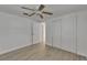 Bedroom with a ceiling fan, wood-look flooring, and a closet for ample storage at 825 Seabreeze Dr, Ruskin, FL 33570