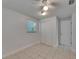 A bedroom features tile floors, ceiling fan and a built-in closet at 825 Seabreeze Dr, Ruskin, FL 33570