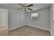This bedroom includes a ceiling fan, light wood-look flooring, and closet at 825 Seabreeze Dr, Ruskin, FL 33570