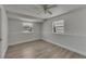 Bedroom with wood-look flooring, fan, and windows at 825 Seabreeze Dr, Ruskin, FL 33570
