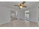 Open dining room featuring tile flooring, ceiling fan, and access to kitchen and sunroom at 825 Seabreeze Dr, Ruskin, FL 33570