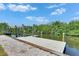 Dock with a modern boat lift with easy access to the beautiful waterways at 825 Seabreeze Dr, Ruskin, FL 33570