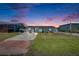 Charming single-story home with a well-maintained lawn and serene sunset backdrop, perfect for tranquil living at 825 Seabreeze Dr, Ruskin, FL 33570