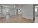 Bright living room features wood-look flooring, ceiling fan, and access to the bathroom and kitchen at 825 Seabreeze Dr, Ruskin, FL 33570