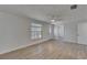 Bright living room features wood-look flooring, ceiling fan, and a large window at 825 Seabreeze Dr, Ruskin, FL 33570