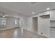 Bright living room features wood-look tile flooring and a modern front door at 825 Seabreeze Dr, Ruskin, FL 33570