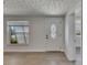 Bright living room showcasing modern flooring and a welcoming white front door at 825 Seabreeze Dr, Ruskin, FL 33570