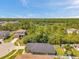 An aerial view of a house with a fenced backyard, set in a lush, green neighborhood at 8504 Tidal Bay Ln, Tampa, FL 33635