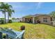 Lush backyard with an inviting patio area, green lawn, and comfortable seating, perfect for relaxation at 8504 Tidal Bay Ln, Tampa, FL 33635
