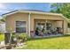 Cozy covered patio with outdoor furniture, perfect for enjoying the backyard view at 8504 Tidal Bay Ln, Tampa, FL 33635