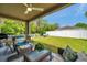 Covered patio offers views of a fenced-in lawn, ideal for relaxation at 8504 Tidal Bay Ln, Tampa, FL 33635