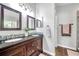 Bathroom with double sink vanity, dark wood cabinets, and granite countertop at 8504 Tidal Bay Ln, Tampa, FL 33635