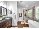 Bathroom featuring a walk-in shower, modern vanity with dark wood cabinets, and updated fixtures at 8504 Tidal Bay Ln, Tampa, FL 33635