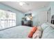 Bedroom with wood-look floors, ceiling fan, and a large window at 8504 Tidal Bay Ln, Tampa, FL 33635