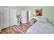 Inviting bedroom with wood-look floors, a closet, and modern decor at 8504 Tidal Bay Ln, Tampa, FL 33635