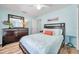 Bedroom with wood-look floors, ceiling fan, and light blue walls at 8504 Tidal Bay Ln, Tampa, FL 33635