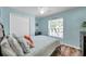 Bedroom with wood-look floors, ceiling fan, and a large window at 8504 Tidal Bay Ln, Tampa, FL 33635