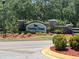 Stone monument at community entrance featuring the neighborhood name 'Country Chase' surrounded by manicured landscaping at 8504 Tidal Bay Ln, Tampa, FL 33635