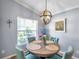 Charming dining room featuring round table, stylish chairs, and decorative lighting fixture at 8504 Tidal Bay Ln, Tampa, FL 33635