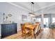 Light and bright dining room with wood floors, table, and modern light fixture at 8504 Tidal Bay Ln, Tampa, FL 33635