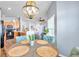 Inviting dining room view with stylish light fixture connecting to kitchen and living areas at 8504 Tidal Bay Ln, Tampa, FL 33635
