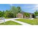 Single-story home with a well-maintained lawn, landscape beds, and a welcoming driveway and walkway at 8504 Tidal Bay Ln, Tampa, FL 33635