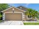 Two car garage on a well maintained one story home with nice landscaping at 8504 Tidal Bay Ln, Tampa, FL 33635