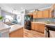 Well-lit kitchen featuring wood cabinets, black appliances, and modern countertops at 8504 Tidal Bay Ln, Tampa, FL 33635