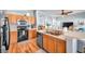 Functional kitchen with wood cabinets, black appliances, and ample counter space at 8504 Tidal Bay Ln, Tampa, FL 33635