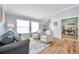 Inviting living room features wood floors, neutral furniture, and natural light from two big windows at 8504 Tidal Bay Ln, Tampa, FL 33635