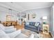 Bright living room with archways, wood floors, comfortable seating, and dining area in the background at 8504 Tidal Bay Ln, Tampa, FL 33635