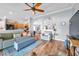Open-concept living room with hardwood floors, a variety of furniture, and a view of the kitchen at 8504 Tidal Bay Ln, Tampa, FL 33635