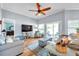 Open-concept living room featuring a ceiling fan, lots of seating, and access to the outside at 8504 Tidal Bay Ln, Tampa, FL 33635