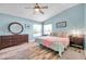 Light-filled main bedroom with vaulted ceilings, wood-look floors, and modern decor at 8504 Tidal Bay Ln, Tampa, FL 33635