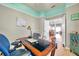 Office with hardwood floors, ceiling trim, office desk and chair, and connection to dining room at 8504 Tidal Bay Ln, Tampa, FL 33635