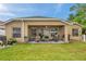 Charming covered patio with comfortable seating, ideal for outdoor gatherings and relaxation at 8504 Tidal Bay Ln, Tampa, FL 33635