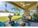 Covered patio with comfortable seating, ceiling fan, and backyard view at 8504 Tidal Bay Ln, Tampa, FL 33635